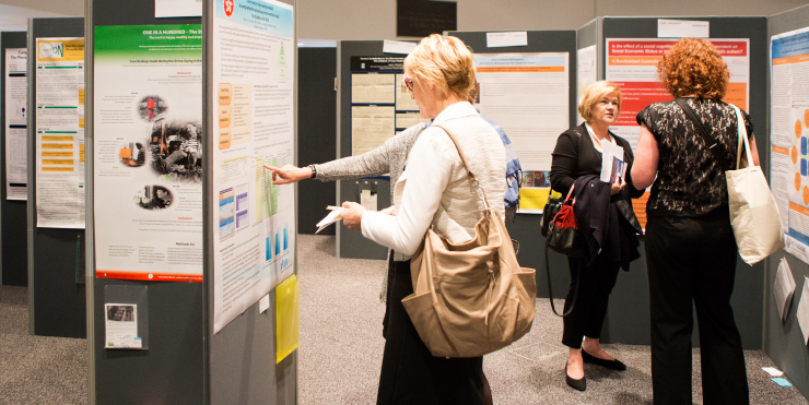 Delegates browsing display boards