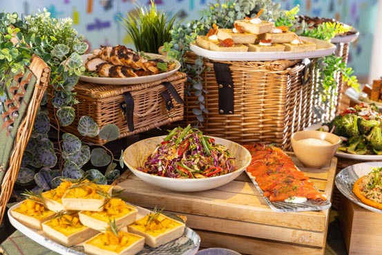 A selection of foods arranged on baskets and wooden cases